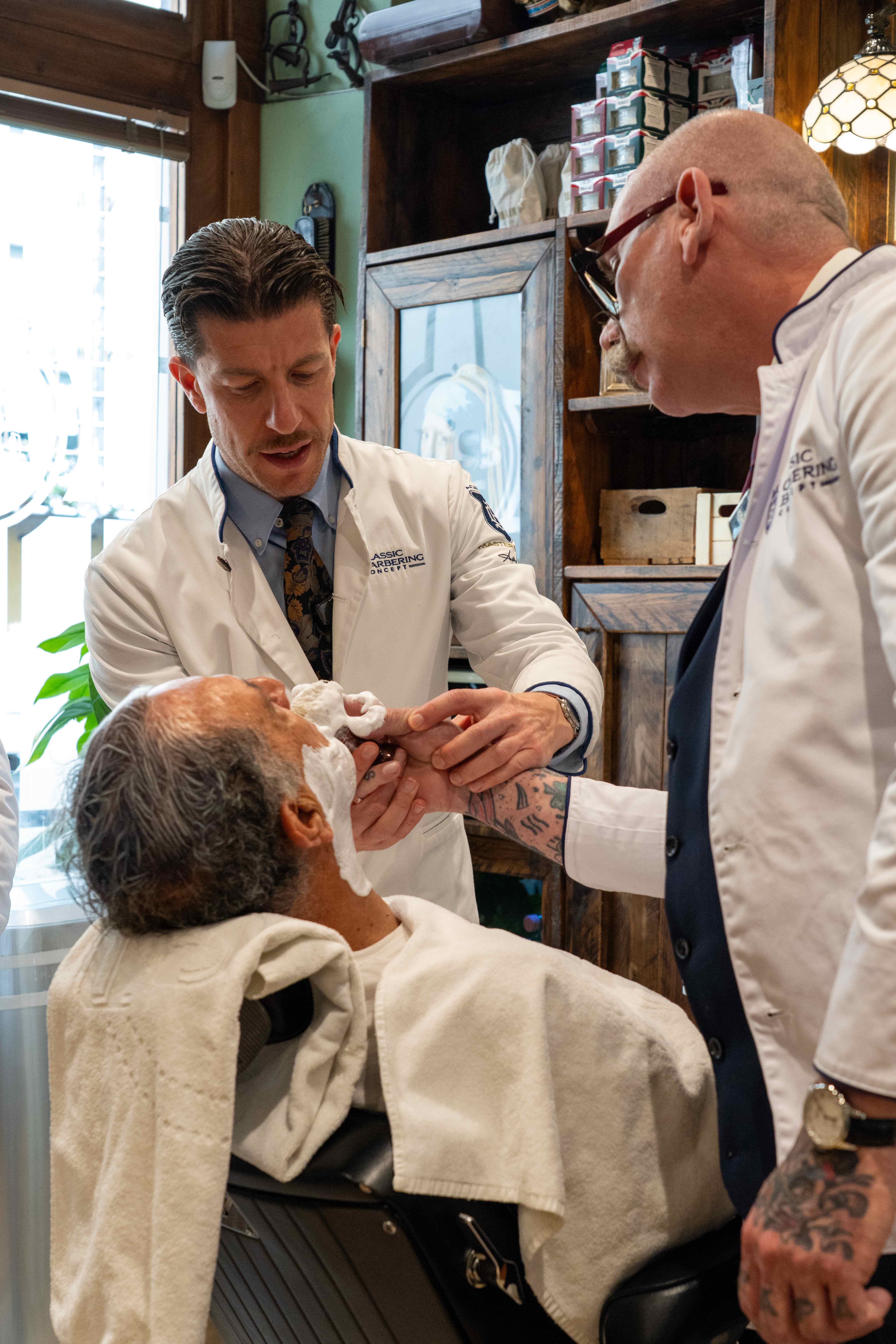 Andrea Cottone conduzindo uma mentoria prática em uma barbearia